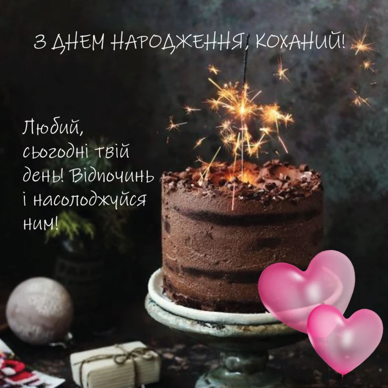 Шоколадний торт зі свічками та подарунками на фоні.