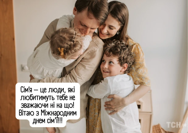 Сім'я обіймається, привітання з Міжнародним днем сім'ї.